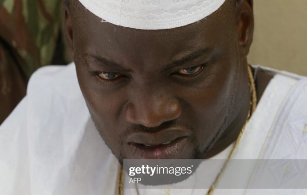 BOUAKE, IVORY COAST:  Wattao (L), one of the chief military commanders of the  New Force rebels, prays 14 November 2004 in Bouake, marking the end of the fasting month of Ramadan and the start of the Eid al-Fitr celebrations.        AFP PHOTO PHILIPPE DESMAZES  (Photo credit should read PHILIPPE DESMAZES/AFP via Getty Images)