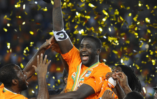 BATA, EQUATORIAL GUINEA - FEBRUARY 08: Ivory Coast's Yaya Toure (2nd L) holds up the trophy as he celebrates with his teammates after winning the 2015 African Cup of Nations final soccer match between Ivory Coast and Ghana at the Bata Stadium on February 08, 2015 in Bata, Equatorial Guinea. (Photo by Mohamed Hossam/Anadolu Agency/Getty Images)