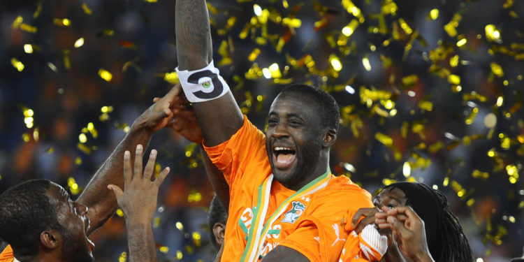 BATA, EQUATORIAL GUINEA - FEBRUARY 08: Ivory Coast's Yaya Toure (2nd L) holds up the trophy as he celebrates with his teammates after winning the 2015 African Cup of Nations final soccer match between Ivory Coast and Ghana at the Bata Stadium on February 08, 2015 in Bata, Equatorial Guinea. (Photo by Mohamed Hossam/Anadolu Agency/Getty Images)