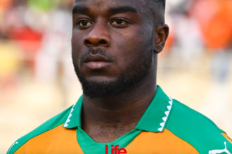 Ivory Coast's national football team player Maxwel Cornet stands at the 'Stade de la Paix' in Bouake on June 10, 2017 during the 2019 African Cup of Nations qualifier football match between Ivory Coast and Guinea.  / AFP PHOTO / ISSOUF SANOGO        (Photo credit should read ISSOUF SANOGO/AFP via Getty Images)
