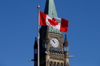 FILE PHOTO: A Canadian flag flies in front of the Peace Tower on Parliament Hill in Ottawa, Ontario, Canada, March 22, 2017. REUTERS/Chris Wattie/File Photo